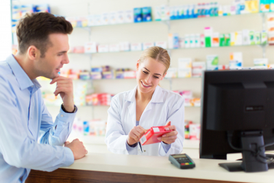 male professional dealing something with the female pharmacist 